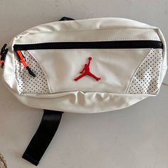 This Item Was Gifted To Me, As I Used To Collect “Fanny Packs”. Air Jordan White Fanny Pack Side Bag, Never Used With Original Tag, White, Faux Leather Material. Gender Neutral Functional White Shoulder Bag For Errands, White Large Capacity Belt Bag For Travel, Large Capacity White Belt Bag For Travel, White Belt Bag With Large Capacity For Travel, White Shoulder Bag With Zipper Pocket For Errands, Large Capacity White Nylon Bags, White Belt Bag With Adjustable Strap For Daily Use, Trendy White Shoulder Belt Bag, White Sporty Bag With Removable Pouch