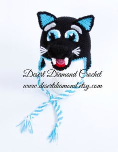 a black cat with blue eyes is on a white background and has a string attached to it