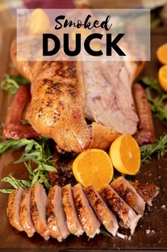 roasted duck with oranges and herbs on a wooden cutting board text reads smoked duck