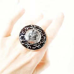 One-of-a-kind statement ring with cloisonne hot enamel and cabochon White Rutilated Quartz. This massive round designer ring is made of sterling silver with handmade engraving on the back side.  The ring size is 8 (18 DE).  Weight is 1.46 oz (41.46 gr). Ring Diameter is (38 mm) The jewelry looks good while wearing on the index finger or third finger - visible well and looks outstanding.  Try it with different styles: cocktail, casual, smart-casual and business to make sure that ring is almost universal for everyday usage. Note: the image on the photo might be bigger than the actual size of the item in order to show details clearly. Enamel is capricious for photographing, that's why colors on the photos can have minor differences comparing to real-life jewelry. Cloisonne Jewelry, Witch Necklace, Ring Luxury, Witch Jewelry, Artisan Rings, Witchy Jewelry, Enamel Necklaces, Enamel Ring, Enamel Earrings