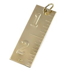 a metal tag with the number two on it's front and back sides, hanging from a gold chain