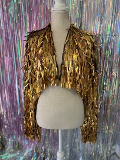 Perfect for music festivals and nights out with friends! sample sale jacket! on sale due to minor imperfections, missing sequins.  Jacket fits size unisex Medium to XXL. Measurements: Circumference 57" Length 15"  Sleeve Length 22" This jacket is ready to ship and cannot be altered.  SOLD AS IS.  For Custom Fur trim & Satin Lining please contact me for custom order.  Please advise, Must be worn with care. Sequins may fall out if tugged or worn roughly.  Please check shop updates for possible pro Tinsel Jacket, Last Disco Bachelorette, Last Disco, Disco Bachelorette, Holographic Gold, Sequin Jacket, Rave Festival, Sequin Fabric, Sample Sale