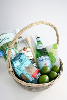 a basket filled with lots of different types of drinks and condiments on top of a table