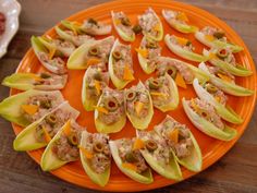 small appetizers are arranged on an orange plate