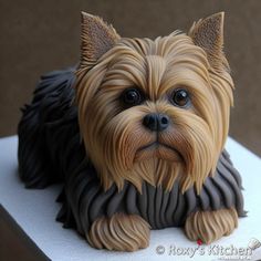 a small dog figurine sitting on top of a cake