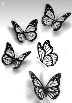 four black and white butterflies flying in the air with one on top of the other