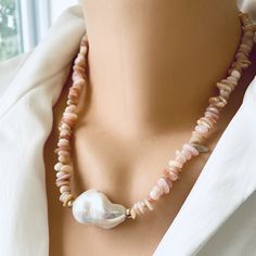 "Add a touch of elegance to your jewelry collection with this stunning Pink Opal Chips and large Fresh Water Baroque Pearl Necklace. Handcrafted with love, this exquisite piece features vibrant pink opal chips beautifully complemented by a large fresh water baroque pearl centerpiece. The necklace is further enhanced by shimmering gold filled beads and a secure closure. Perfect for any occasion, this unique necklace will make a thoughtful and unforgettable gift for her. With a length of 18.5 inches, it effortlessly adds a pop of color and sophistication to any outfit. Embrace the beauty and grace of pink opal jewelry with this timeless piece. MATERIALS: Pink Opal Freshwater Large Baroque Pearl  Gold filled Measures 47cm or 18.5\"inches All Loulia Pearl Jewelry orders are carefully packaged Pearl White Beaded Baroque Pearl Necklace, Elegant Pearl Necklaces With Colorful Beads, Elegant Pearl Crystal Necklace With Colorful Beads, Elegant Gemstone Beads Shell Necklace As Gift, Pearl White Necklace With Round Gemstone Beads, Elegant Shell Necklace With Polished Round Beads, Elegant Shell Necklace With Polished Beads, Pearl White Necklaces With Faceted Beads, Baroque Pearl Necklaces With Natural Stones And Round Beads