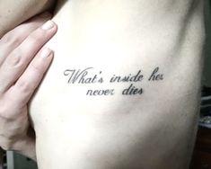 a man with a tattoo on his chest saying what's inside he never dies