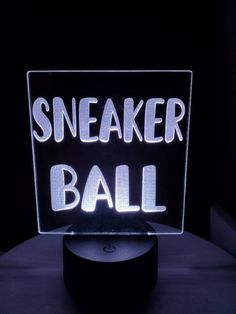 a neon sign that says sneaker ball on it