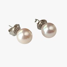 These stud-style earrings, crafted from 14K white gold, are of exceptional quality and elegance. The pearls used are cultured saltwater Akoya pearls, responsibly sourced from Japan. The round shape of the pearls combined with their excellent luster gives them a stunning appearance. They showcase a white color with visible orient, adding to their allure. The pearls' surface is very clean, free from visible inclusions, enhancing their overall beauty. Classic White Akoya Pearl Earrings, Classic Hypoallergenic Akoya Pearl Earrings, Hypoallergenic Akoya Pearl Earrings In Classic Style, Hypoallergenic Classic Akoya Pearl Earrings, Classic Akoya Pearl Earrings, Classic Hypoallergenic Pearl White Pearl Earrings, Classic White Gold Hypoallergenic Pearl Earrings, Classic Hypoallergenic White Gold Pearl Earrings, Stud Style