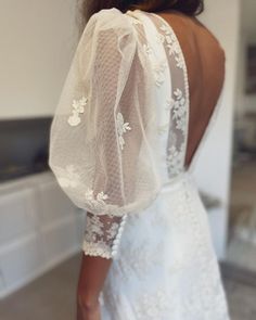 the back of a woman wearing a white wedding dress