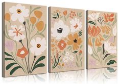 three canvases with flowers painted on them, one in beige and the other in orange