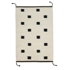 a rug with black and white designs on the front, hanging from a metal hook