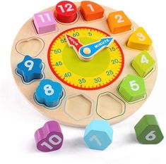 a wooden clock with numbers and shapes around it