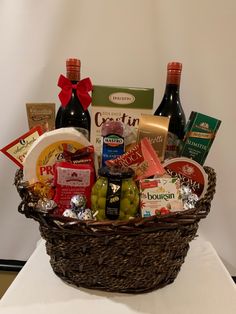 a basket filled with lots of different types of food and condiments on top of a table