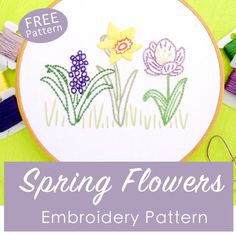 the embroidery pattern for spring flowers is displayed in front of some sewing needles and thread