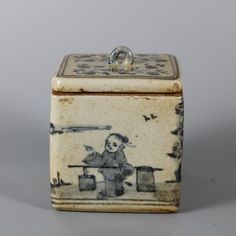 a small box with a drawing of a boy sitting on a bench