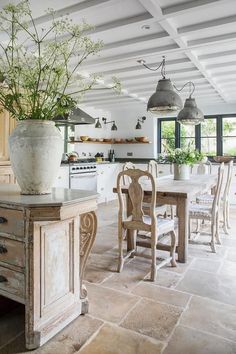 a kitchen with an island, table and chairs