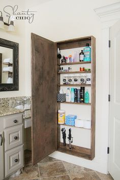 an open medicine cabinet in the corner of a bathroom