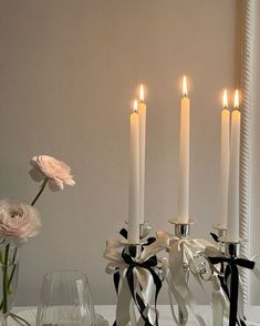 a table topped with candles and vases filled with flowers