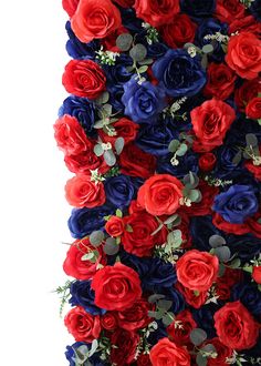 red, white and blue flowers are arranged on a wall