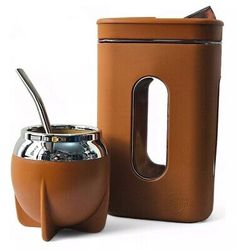 a coffee pot with a spoon in it next to a canister