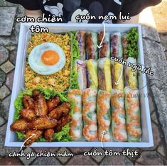 a tray filled with different types of food on top of a stone floor next to a person