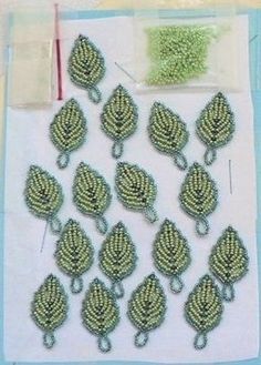 several pieces of green beaded fabric on a table