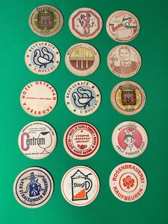 several different types of beer badges on a green surface