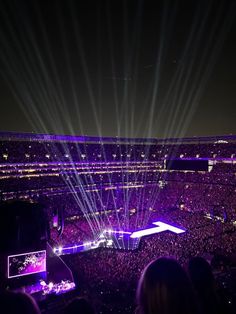 an aerial view of a concert venue at night with bright lights shining down on the audience