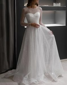 a woman in a white wedding dress sitting on a chair