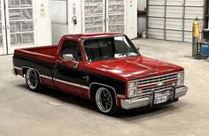 a red and black truck parked in a garage