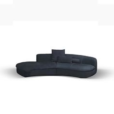 a curved couch with pillows on it