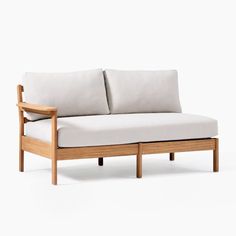 a wooden couch with two pillows on it