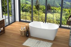 a large white bath tub sitting on top of a wooden floor next to a window