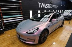 two electric cars are parked in a showroom