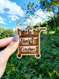 someone holding up a wooden sign that says no shelf control in front of some grass