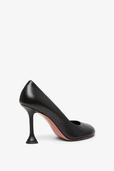 Black leather pumps from Amina Muaddi. The Iris pumps are made of black leather, with rounded tips and sit on a mini coctail stiletto heel measuring 95 mm.Measurements: L30 x H13 x W9 cmMade in Italy