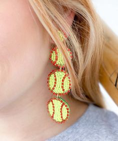 a close up of a person wearing some kind of beaded earring on their ear