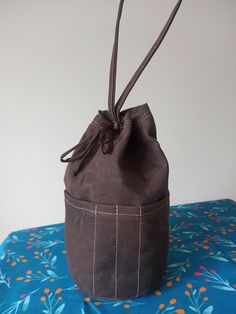 a brown bag sitting on top of a blue table cloth