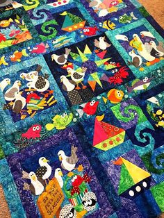 a quilt made to look like it is on the floor with many different things in it