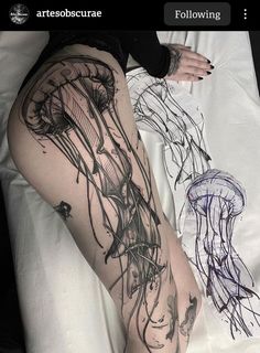 a woman laying on top of a bed next to a jellyfish and an octopus tattoo