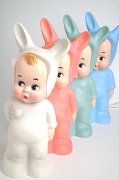 a group of small plastic toy rabbits standing next to each other