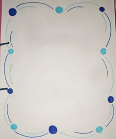 a white sheet of paper with blue circles on it and black crayon markers