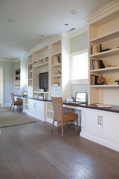 a living room filled with lots of furniture and bookshelves next to a window