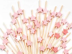 pink stars are arranged on top of sticks