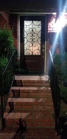 the front door of a house with steps leading up to it