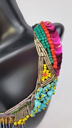 Branded by Seyyah, this colorful "social necklace" is a perfect staple pieces to elevate your everyday look. Crochet based embroidery statement necklace Adorned with seed and bugle beads, sequins, and semiprecious gemstones Two snaps to adjust the length Black crochet base length: 19-21", weight 1.6 oz About the brand: Seyyah is a brand that offers bold, unique, and colorful accessories inspired by travels around the world... and most importantly help to empower women. The brand "provides fair w Embellished Multicolor Necklace For Party, Embellished Multicolor Party Necklaces, Multicolor Embellished Party Necklaces, Multicolor Embellished Party Necklace, Party Embellished Beaded Necklaces With Round Beads, Unique Colorful Party Beads, Festival Multicolor Beaded Bib Necklace, Unique Multicolor Beaded Necklaces For Party, Multicolor Embellished Festive Jewelry