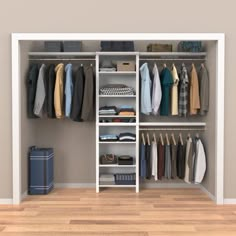 an open closet with clothes and suitcases on the floor, in front of a beige wall