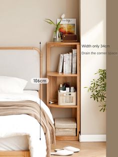 a bedroom with a bed, bookshelf and plant on the floor next to it